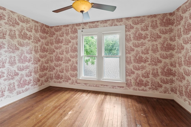 empty room featuring ceiling fan and hardwood / wood-style flooring