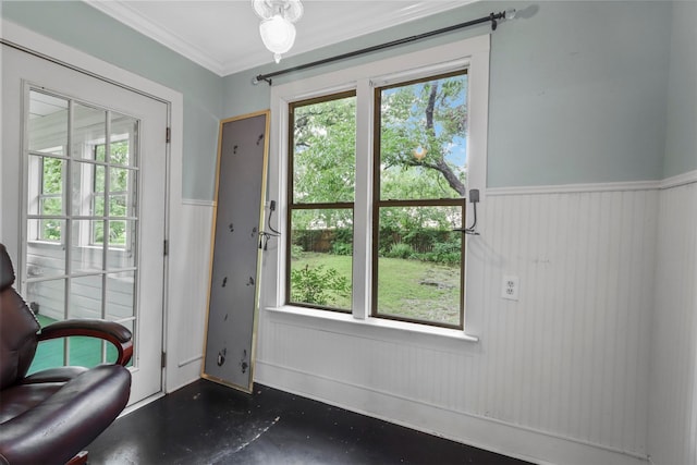 interior space with crown molding, plenty of natural light, and concrete flooring