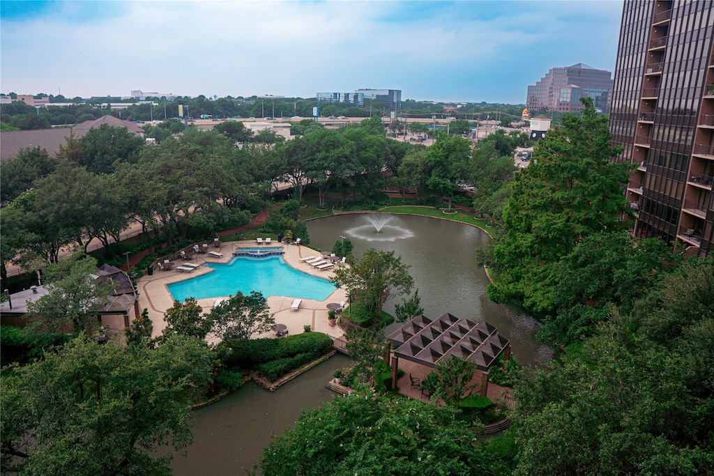 view of swimming pool featuring a water view