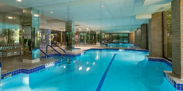 view of swimming pool with an indoor hot tub