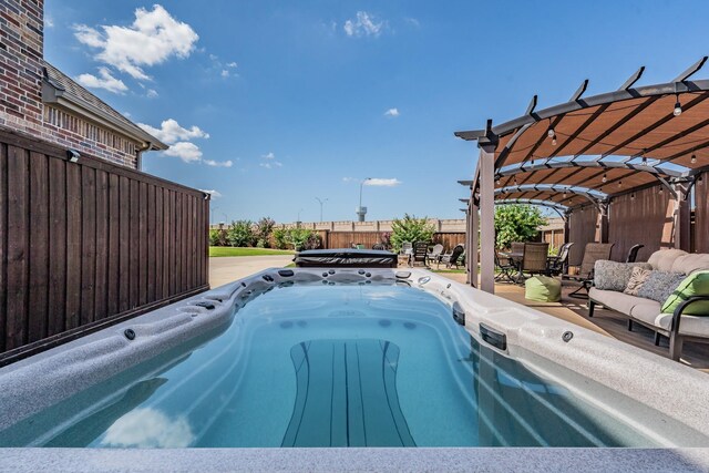 view of swimming pool featuring outdoor lounge area, a patio, and a hot tub