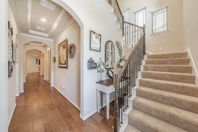 corridor featuring hardwood / wood-style flooring and crown molding