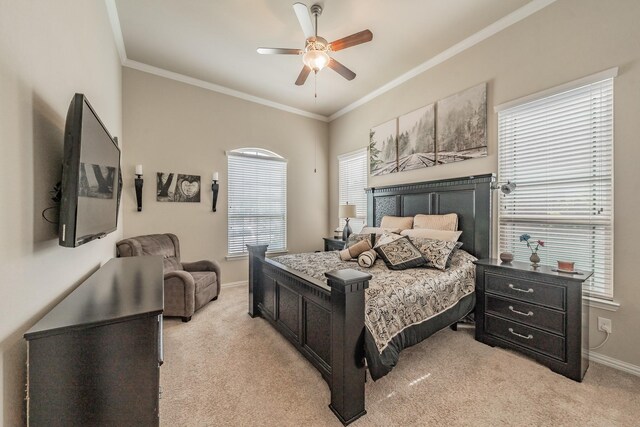 carpeted bedroom featuring ceiling fan and crown molding