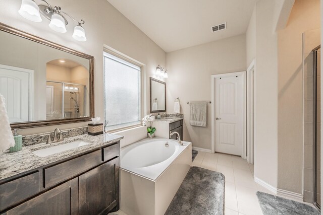 bathroom with tile patterned floors, vanity, and separate shower and tub