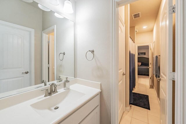 bathroom with tile patterned flooring and vanity