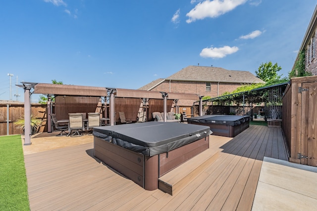 wooden deck with a covered hot tub