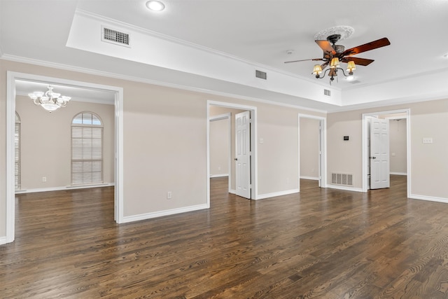 empty room with ornamental molding, dark wood-type flooring, a raised ceiling, and ceiling fan with notable chandelier