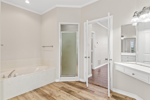 bathroom with crown molding, hardwood / wood-style floors, separate shower and tub, and vanity