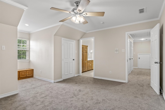 unfurnished bedroom featuring ornamental molding, light carpet, and ensuite bathroom