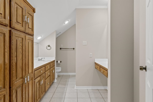 bathroom with tile flooring, lofted ceiling, vanity, and toilet