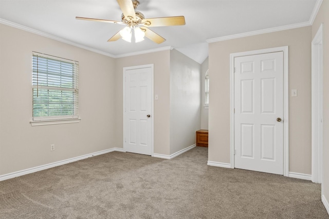 unfurnished bedroom featuring ornamental molding, light colored carpet, and ceiling fan