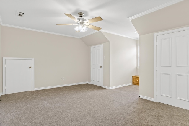 unfurnished bedroom featuring crown molding, carpet flooring, ensuite bathroom, ceiling fan, and vaulted ceiling