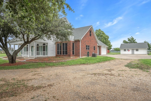 view of side of home with a garage and central AC unit