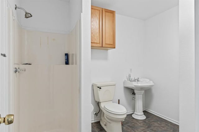 bathroom with toilet and tile floors