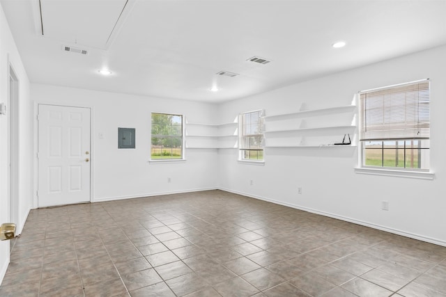 unfurnished room with tile floors