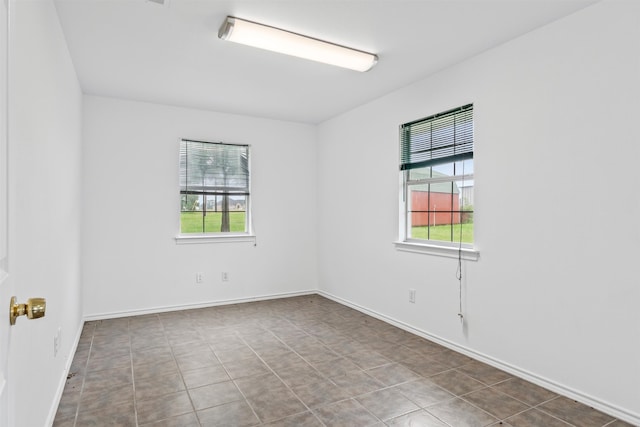 unfurnished room featuring tile flooring