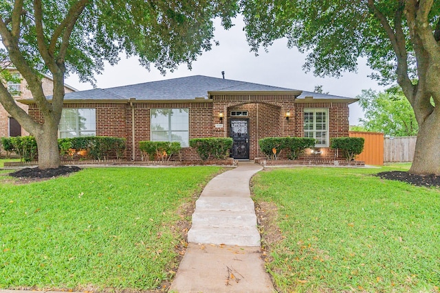 ranch-style home featuring a front yard