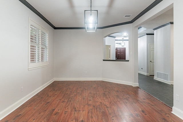 empty room featuring crown molding and dark hardwood / wood-style floors