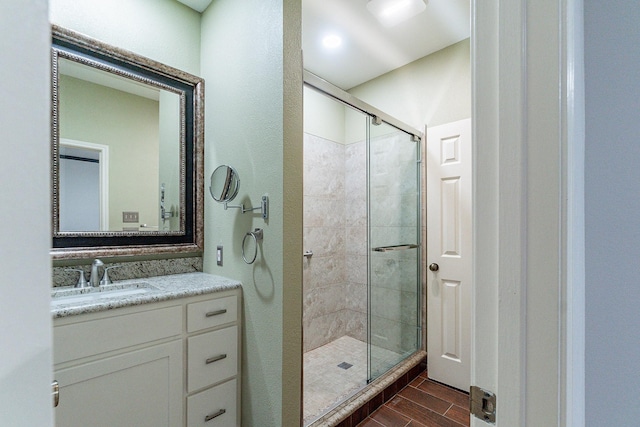 bathroom with vanity, wood-type flooring, and an enclosed shower