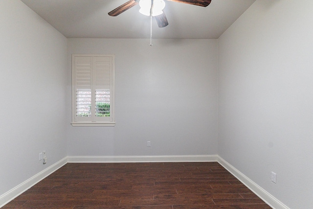 spare room featuring ceiling fan and dark wood-type flooring