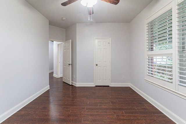 unfurnished bedroom with ceiling fan, a closet, and dark wood-type flooring