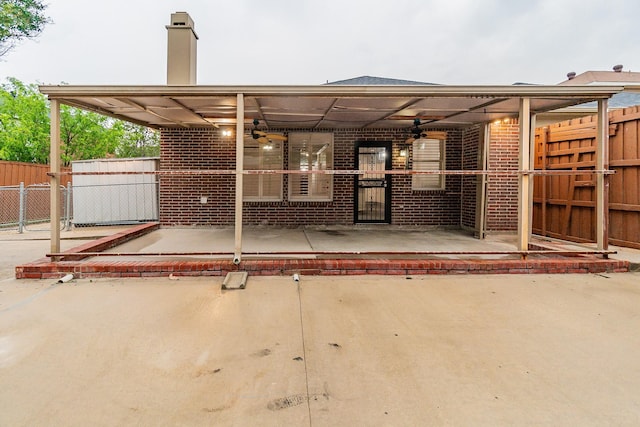 rear view of house with ceiling fan