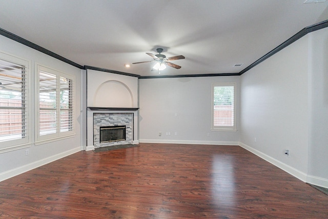 unfurnished living room with a fireplace, dark hardwood / wood-style floors, ceiling fan, and crown molding