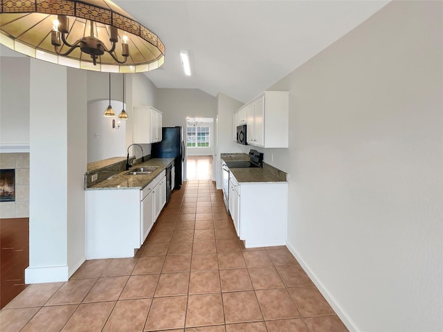 kitchen featuring white cabinets, black appliances, an inviting chandelier, hanging light fixtures, and light tile patterned floors