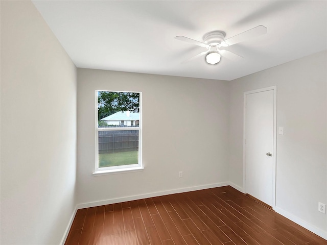 spare room with ceiling fan and dark wood-type flooring