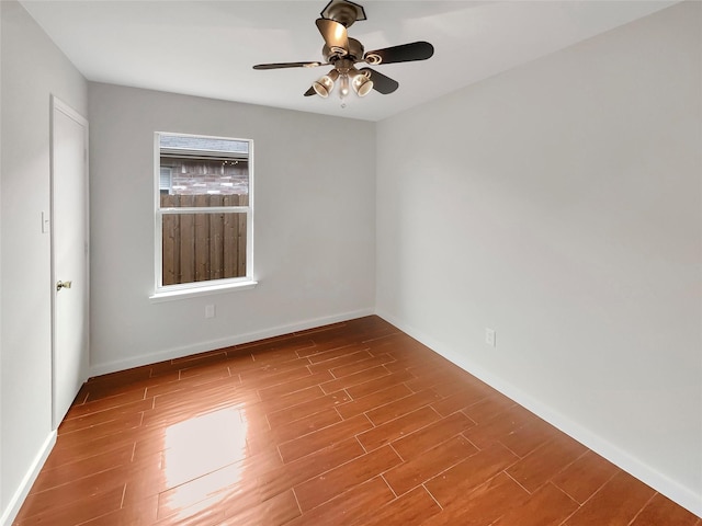 spare room featuring wood-type flooring and ceiling fan