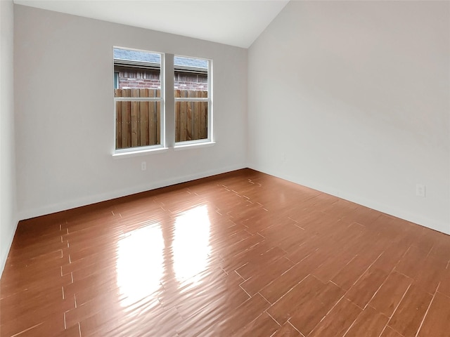 empty room with lofted ceiling