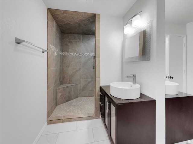 bathroom featuring vanity and a tile shower