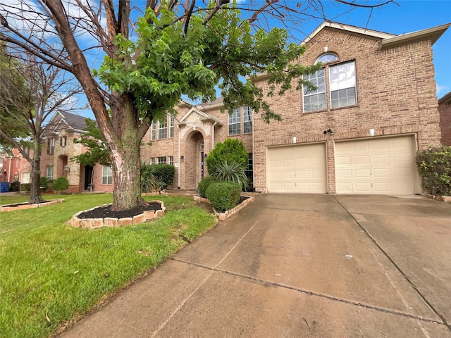 view of front of property featuring a front yard and a garage