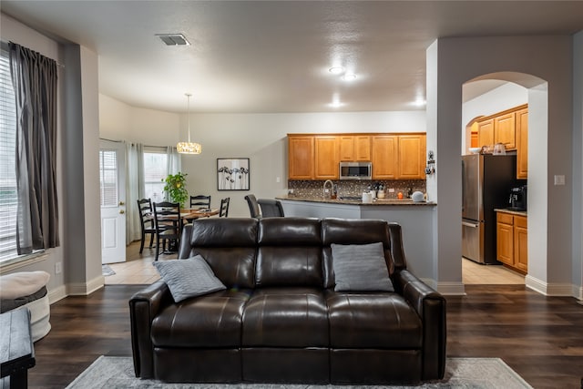 living room with tile patterned flooring and sink