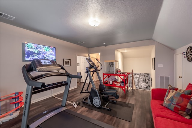 workout room featuring hardwood / wood-style flooring, a textured ceiling, and lofted ceiling