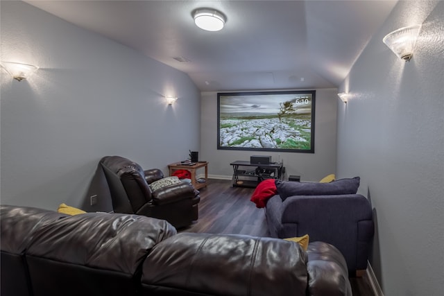 cinema room featuring vaulted ceiling and wood-type flooring