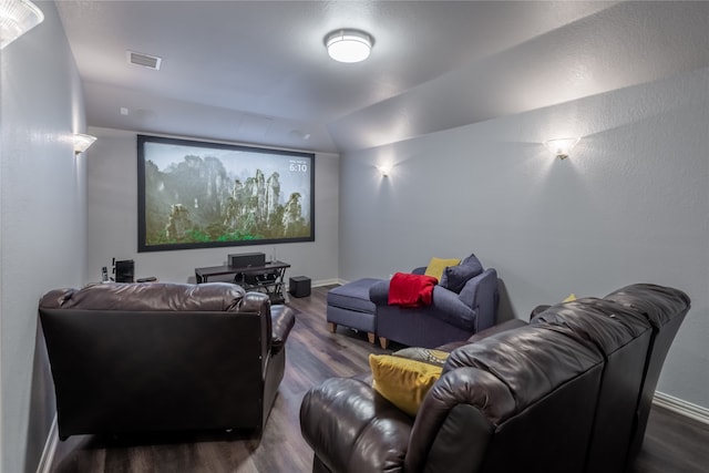 home theater room featuring lofted ceiling and hardwood / wood-style floors