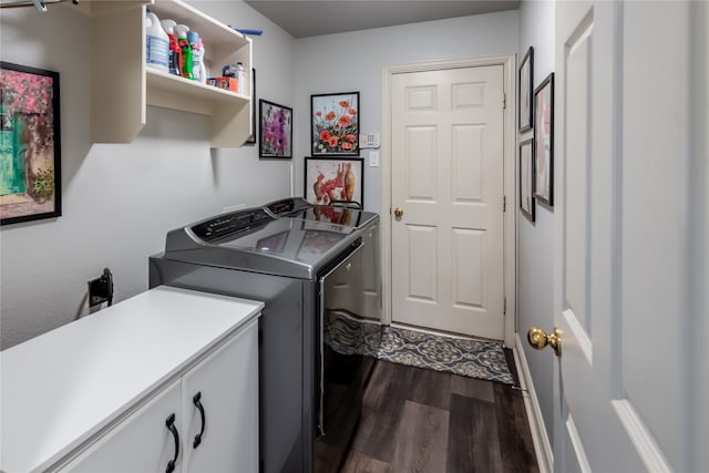 clothes washing area featuring cabinets, dark hardwood / wood-style floors, and washer and dryer