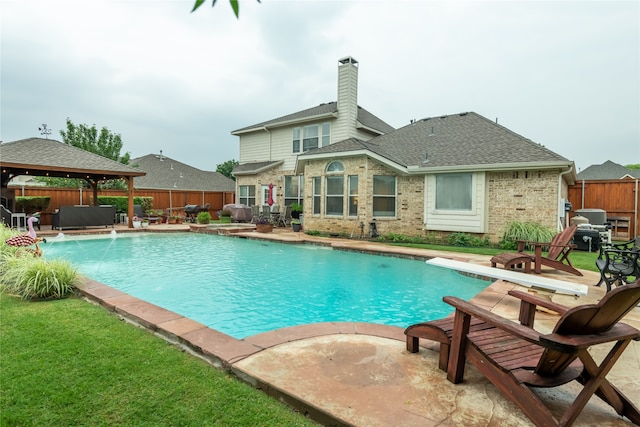 view of swimming pool with a patio area, a gazebo, and pool water feature