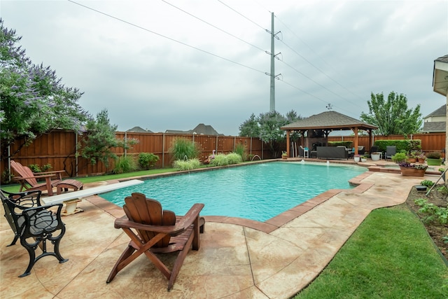 view of swimming pool with a patio, a gazebo, and a diving board