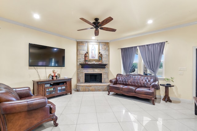 living room featuring light tile floors, ceiling fan, a fireplace, and crown molding