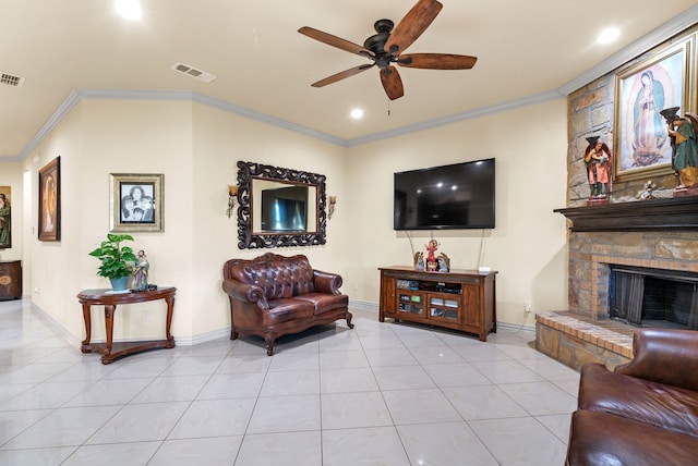 living room featuring crown molding, ceiling fan, a fireplace, and tile floors