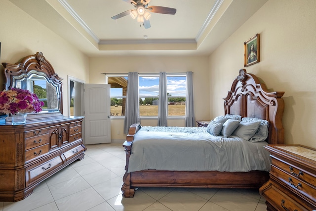 tiled bedroom featuring ceiling fan and a tray ceiling