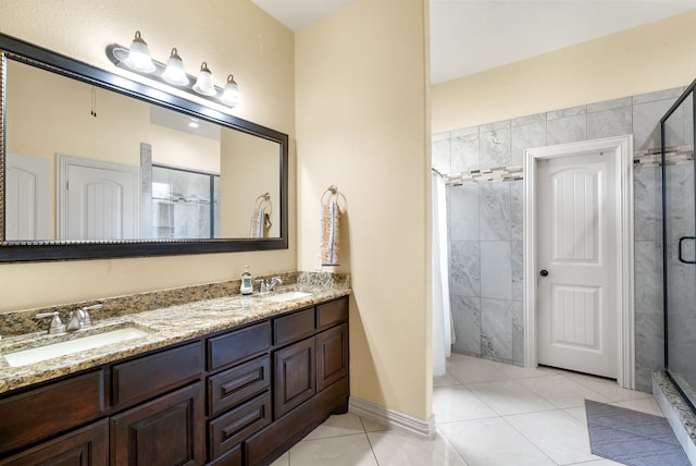 bathroom featuring tile floors, vanity with extensive cabinet space, an enclosed shower, and double sink