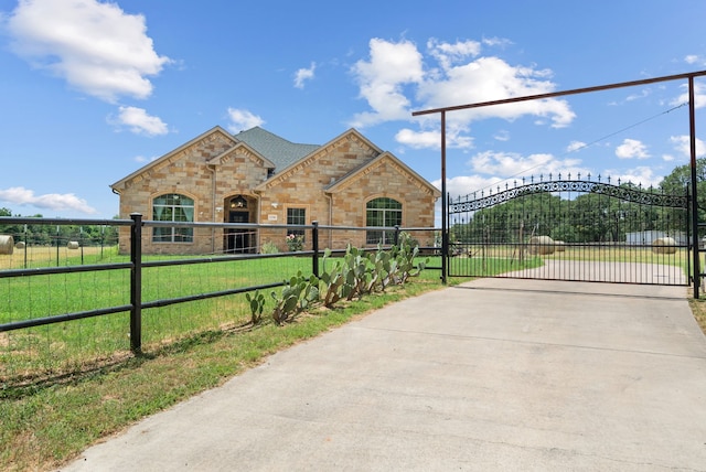 view of gate featuring a lawn