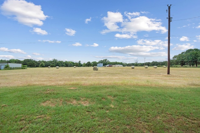 view of yard with a rural view