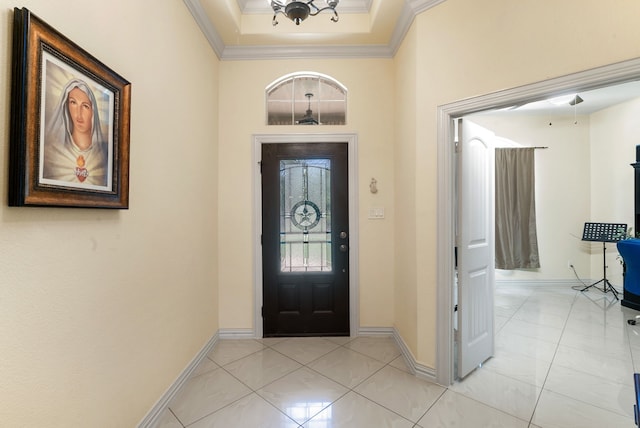 tiled entryway with a raised ceiling