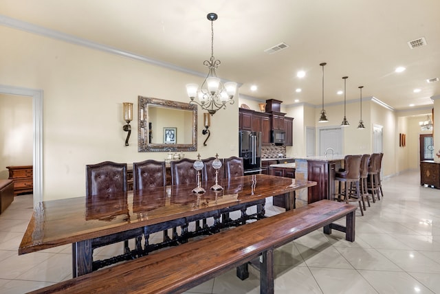 dining room featuring crown molding, a chandelier, and light tile floors