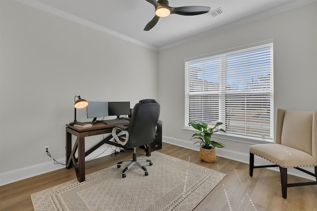 home office featuring a healthy amount of sunlight, hardwood / wood-style floors, ceiling fan, and crown molding