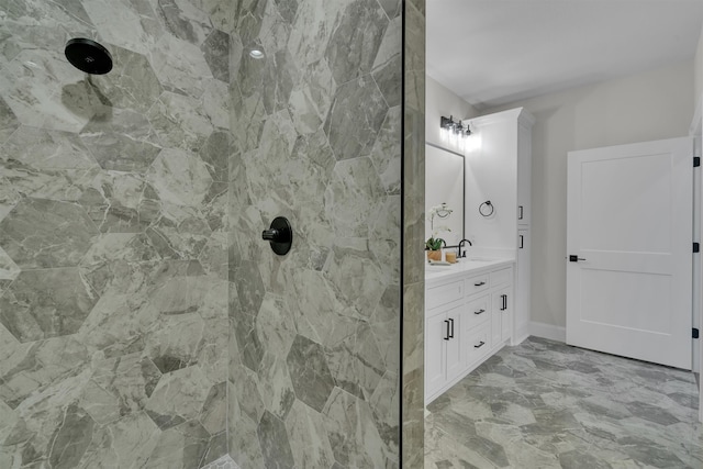 bathroom featuring tiled shower, double sink vanity, and tile floors